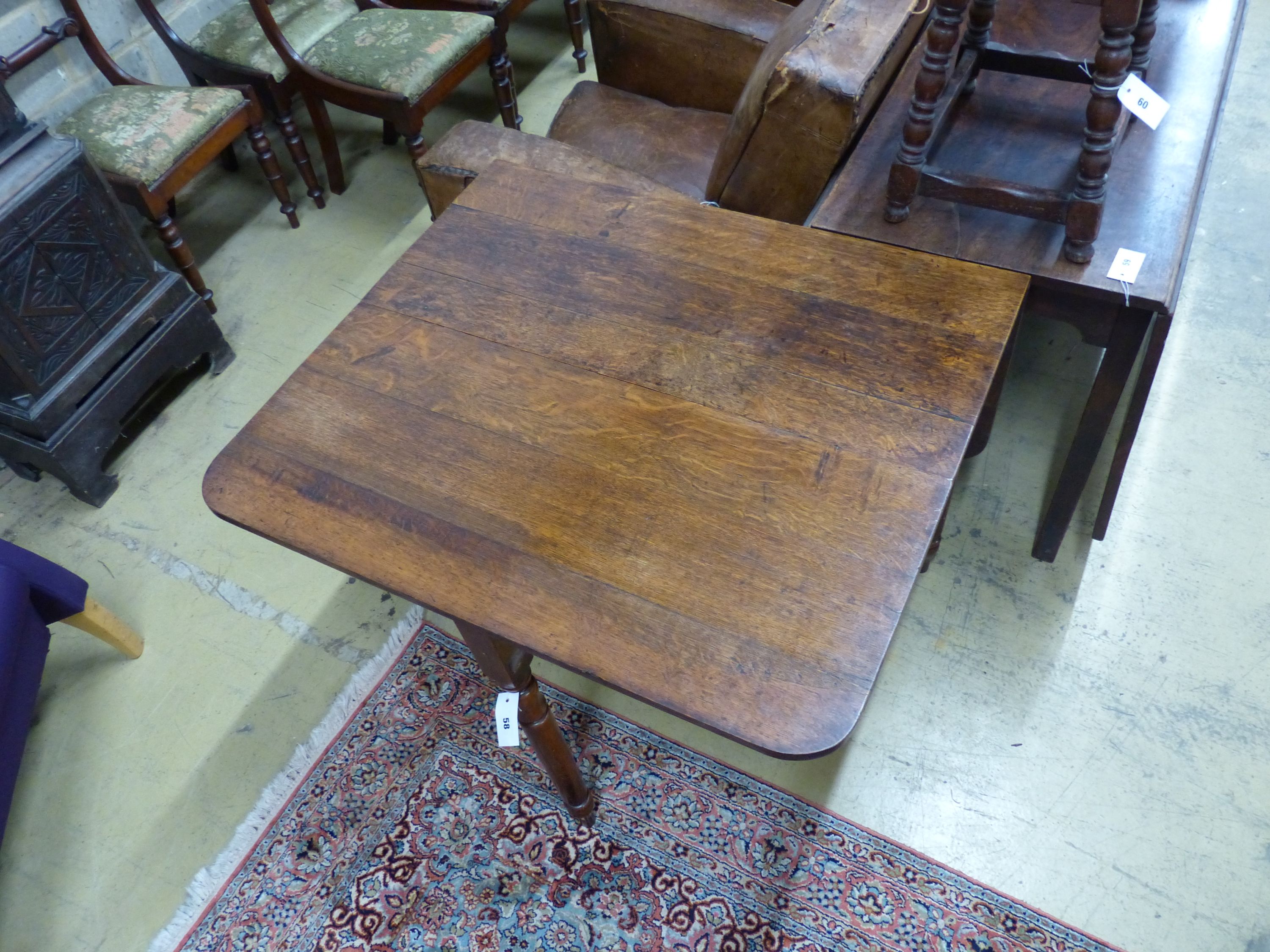 An early Victorian oak drop leaf dining table, length 90cm